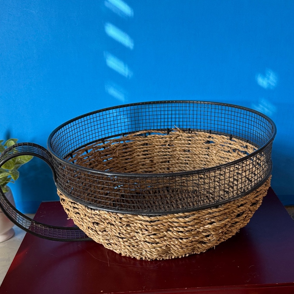 Vintage metal and woven basket designed to look like a large coffee cup.
